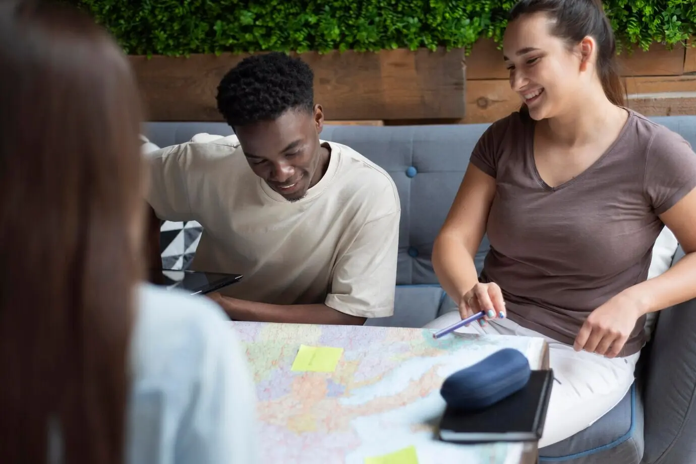 A group of friends making plans for a trip in a cafe
